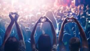 Love to music Male and female heart shaped hands and crowd or audience at live music concert  WhatsHappeningTodaycom